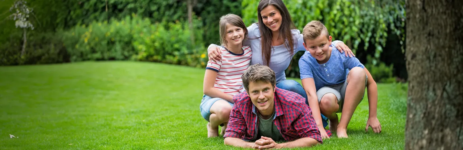 family laying in grass