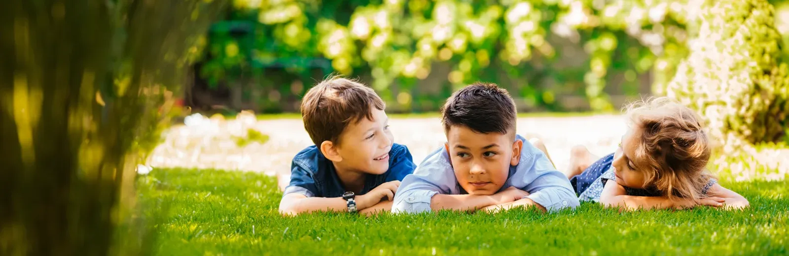 kids laying in grass