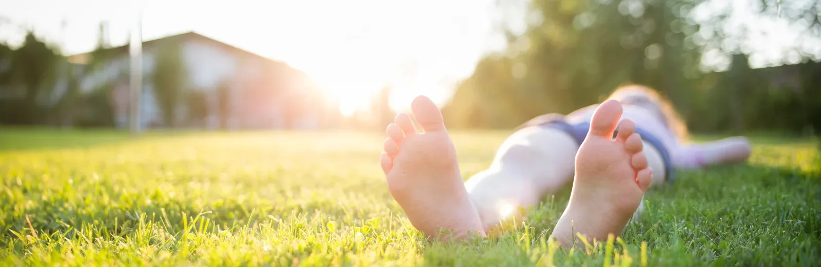 kid relaxing in grass